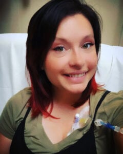 Young woman smiling wile receiving an IGIG infusion