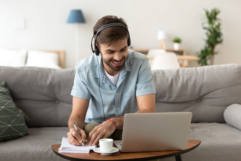 Man Working On Laptop At Home